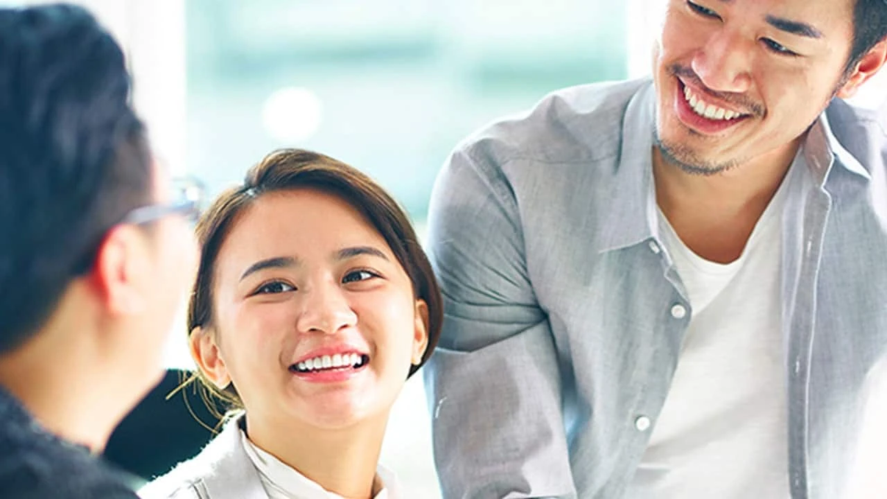 Two mint chocolate milkshakes with whipped cream and green sprinkles.