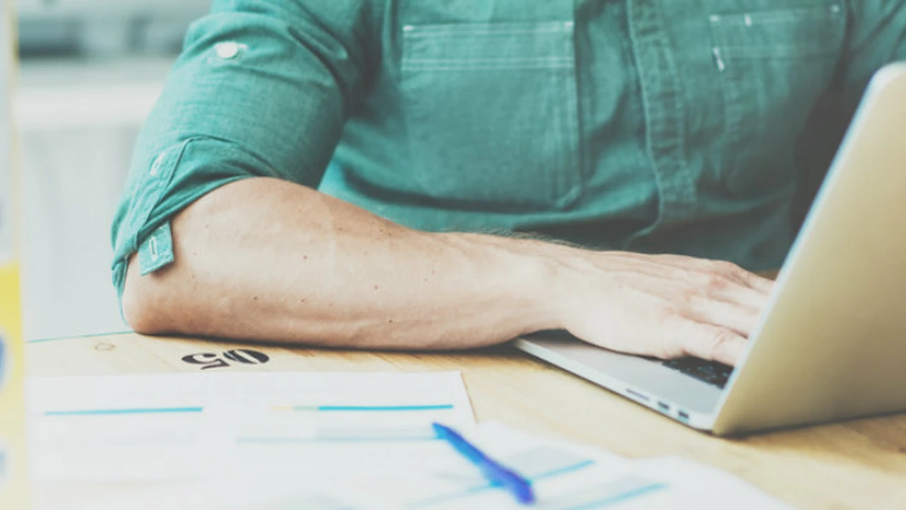 overhead view of corned beef sliced and on a platter with cabbage, potatoes, and carrots
