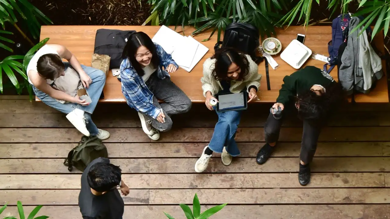 Close up on a plate of mashed potatoes, topped with baked pork chops with cream of mushroom soup, and a side of green beans.