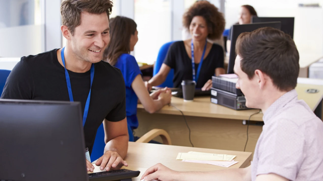 Close up on a plate of mashed potatoes, topped with baked pork chops with cream of mushroom soup, and a side of green beans.