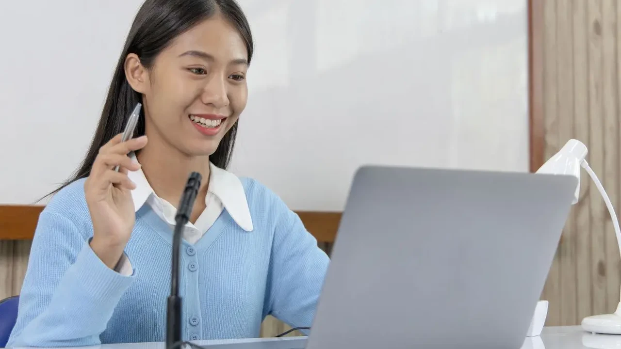 Close up on a plate of mashed potatoes, topped with baked pork chops with cream of mushroom soup, and a side of green beans.