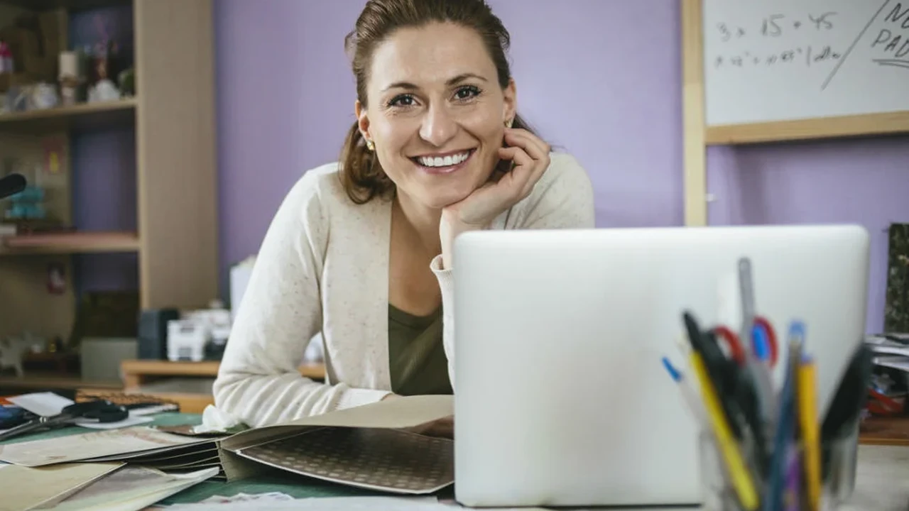 Close up on a plate of mashed potatoes, topped with baked pork chops with cream of mushroom soup, and a side of green beans.